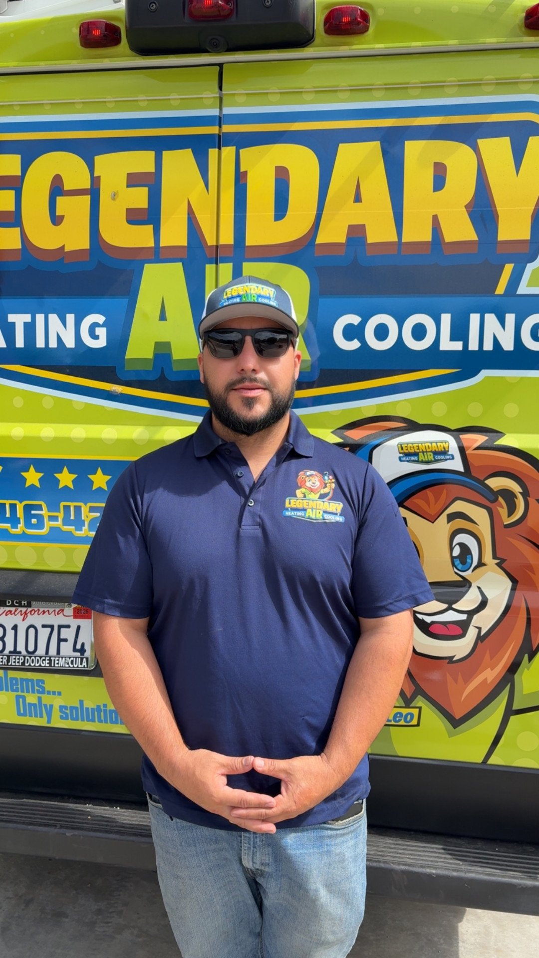 Rudy Vargas, founder of Legendary Air Heating Cooling, standing in front of the company's service van
